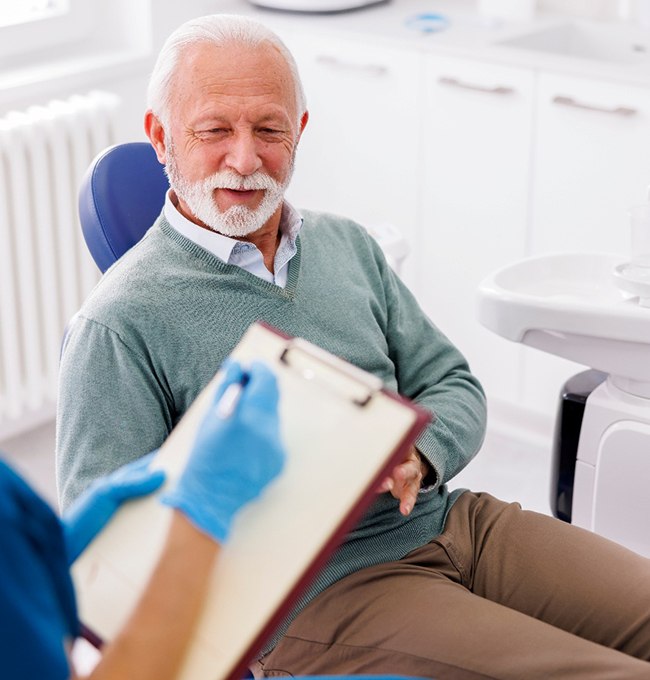 a dentist speaking with a patient