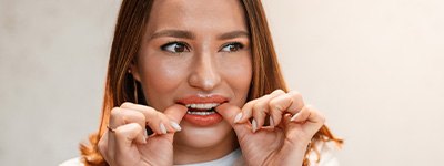 Closeup of patient putting on clear aligner