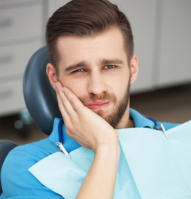 model of a dental implant in Chaska being placed in a patient’s mouth