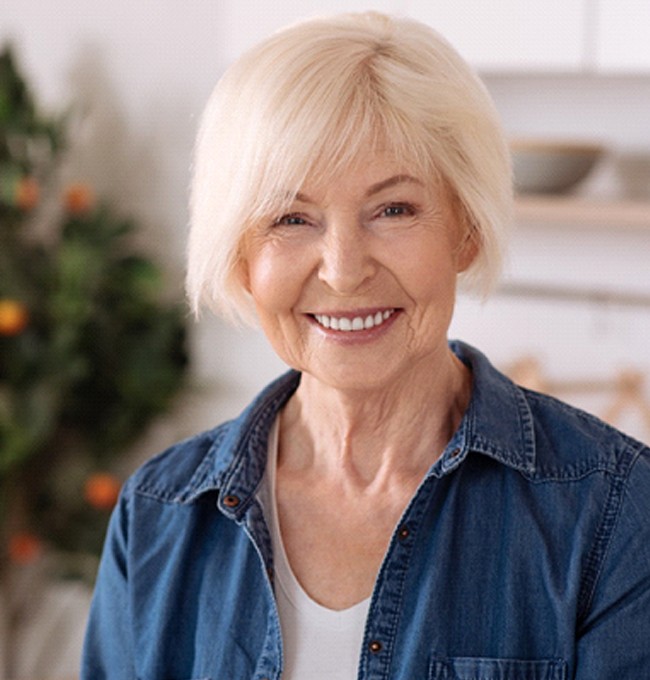 patient smiling after getting dental implants in Chaska