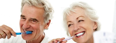 older couple brushing teeth together