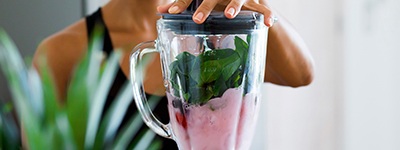a person making a smoothie at home