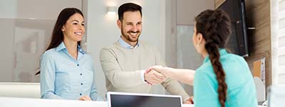 dental assistant shaking hands with a patient