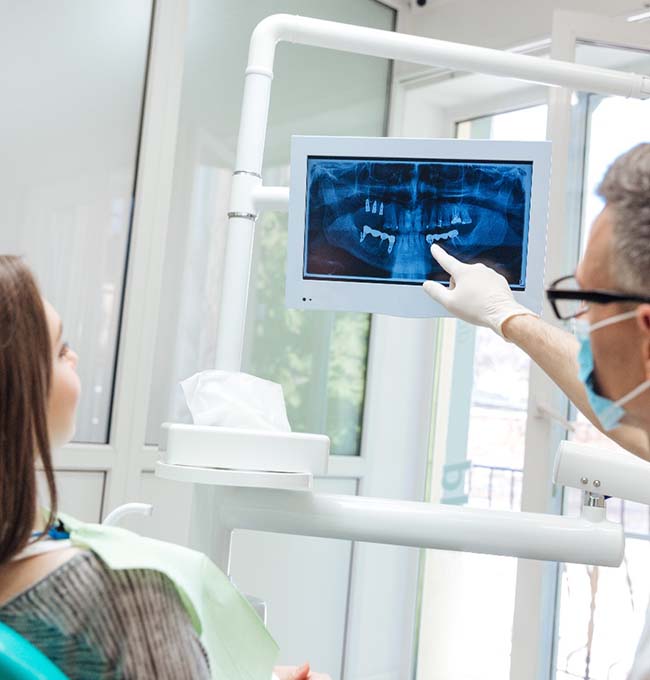 implant dentist in Chaska showing a patient their X-rays