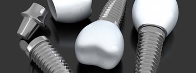 three dental implants lying on a flat surface