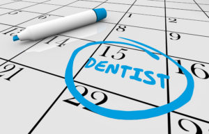 Closeup of calendar reminding patient of upcoming dental checkups