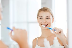 Young woman brushing her teeth