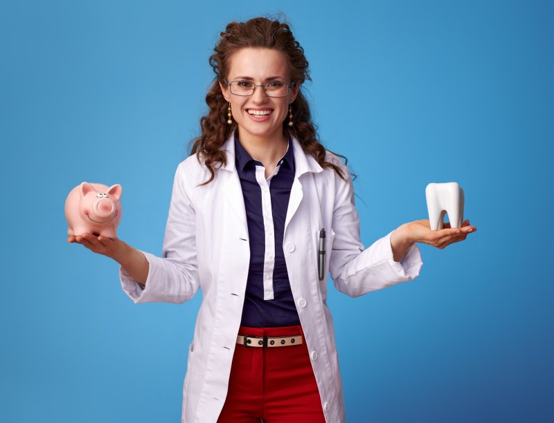 Woman holding tooth and money.