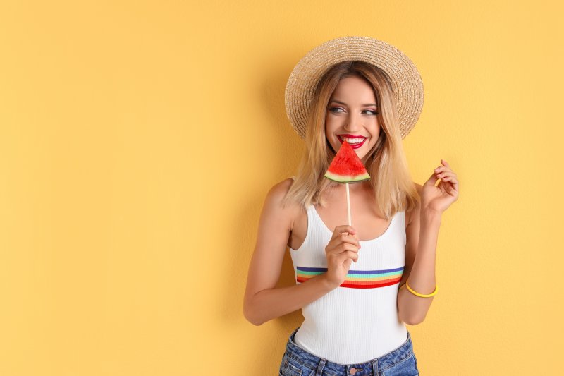 woman enjoying watermelon after cosmetic dental treatment in Chaska
