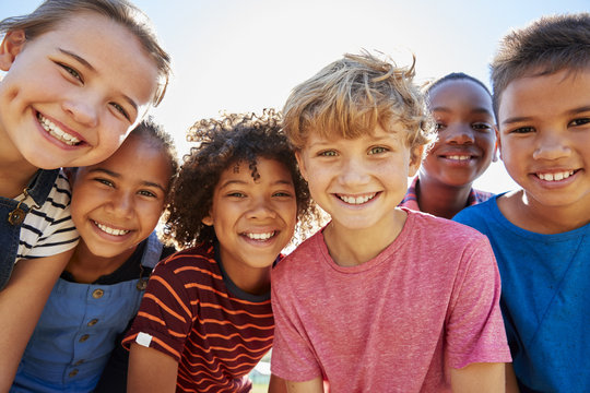 group of smiling children celebrating Children’s Dental Health Month