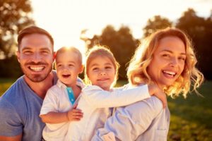 a family smiling after doing a spring cleaning for their teeth