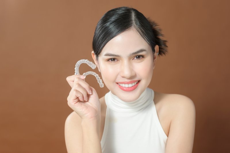 Lady gladly shows off Invisalign clear aligners