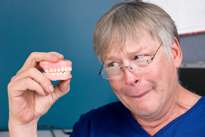Patient examining their smelly dentures