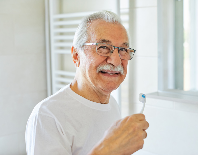 Older patient smiling with their dentures