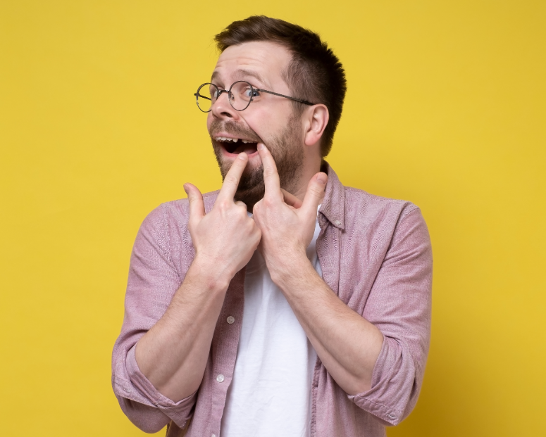 Man pointing at missing tooth